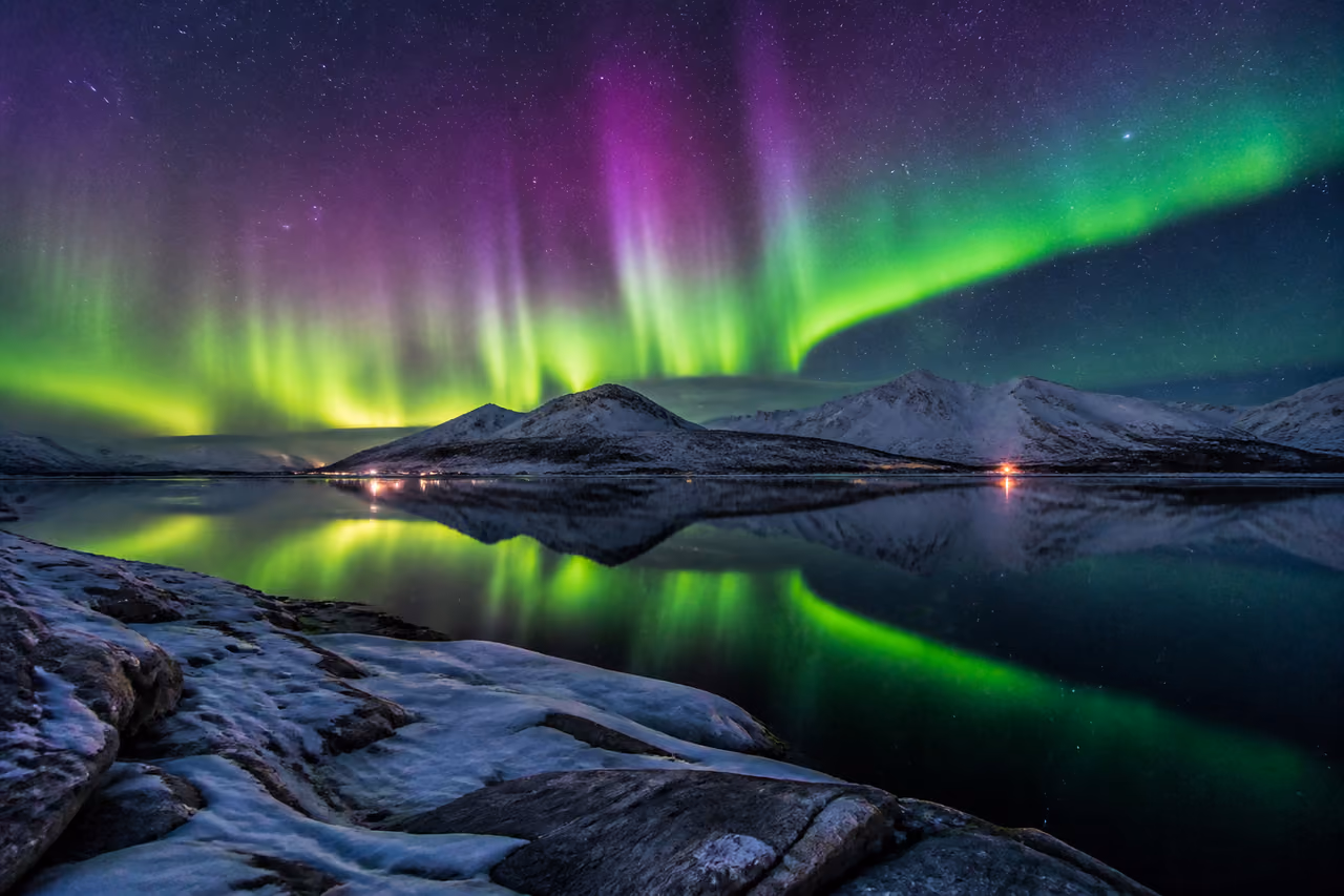 Vibrant Northern Lights Reflecting Over a Frozen Arctic Lake