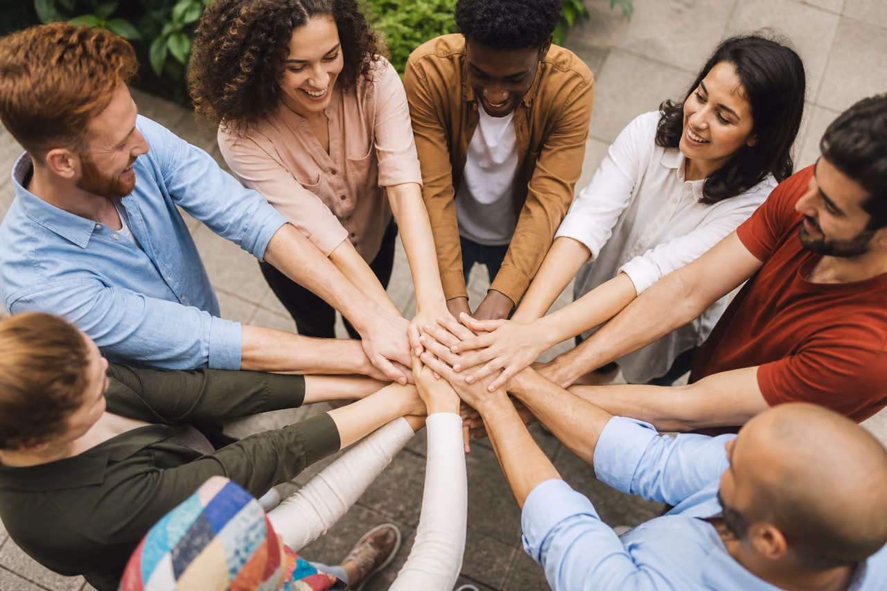 Diverse Group of People Joining Hands in Unity