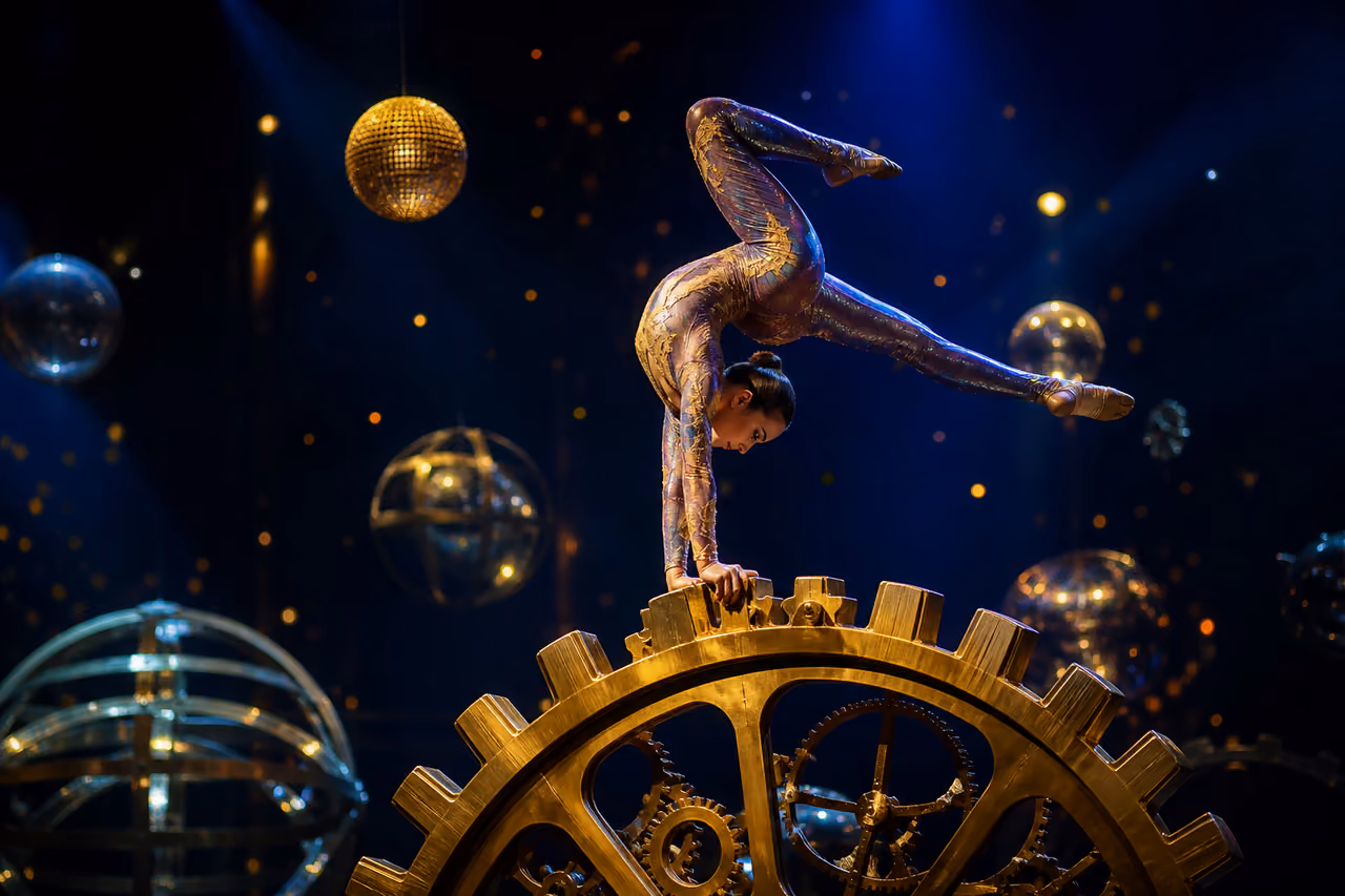 Acrobat Performing on a Giant Golden Gear in a Surreal Circus