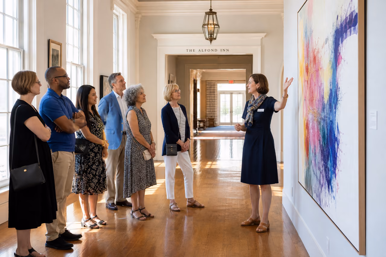 Group Taking an Art Tour Inside an Elegant Inn Gallery