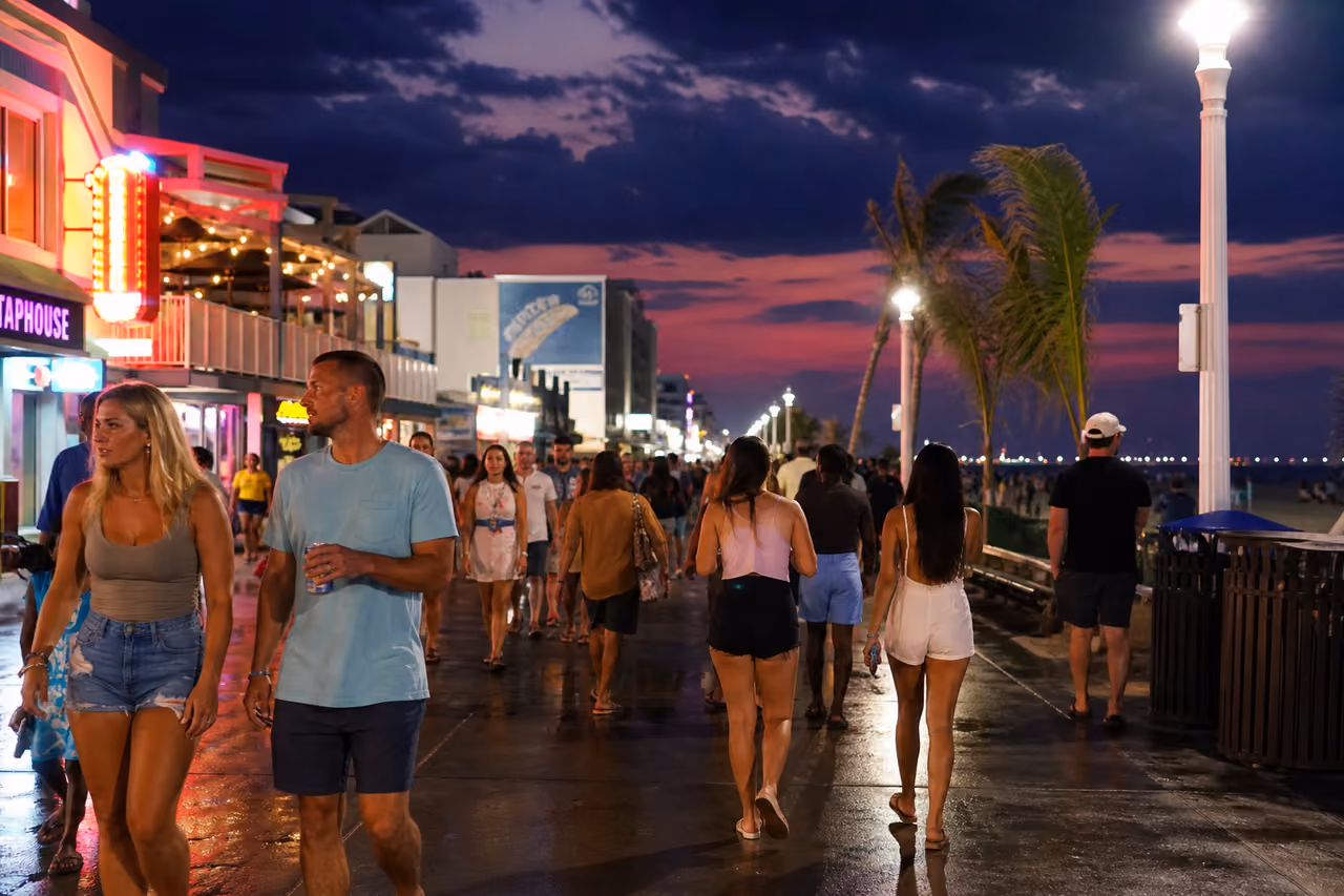 People Socializing Along the Neon Lit Virginia Beach Boardwalk