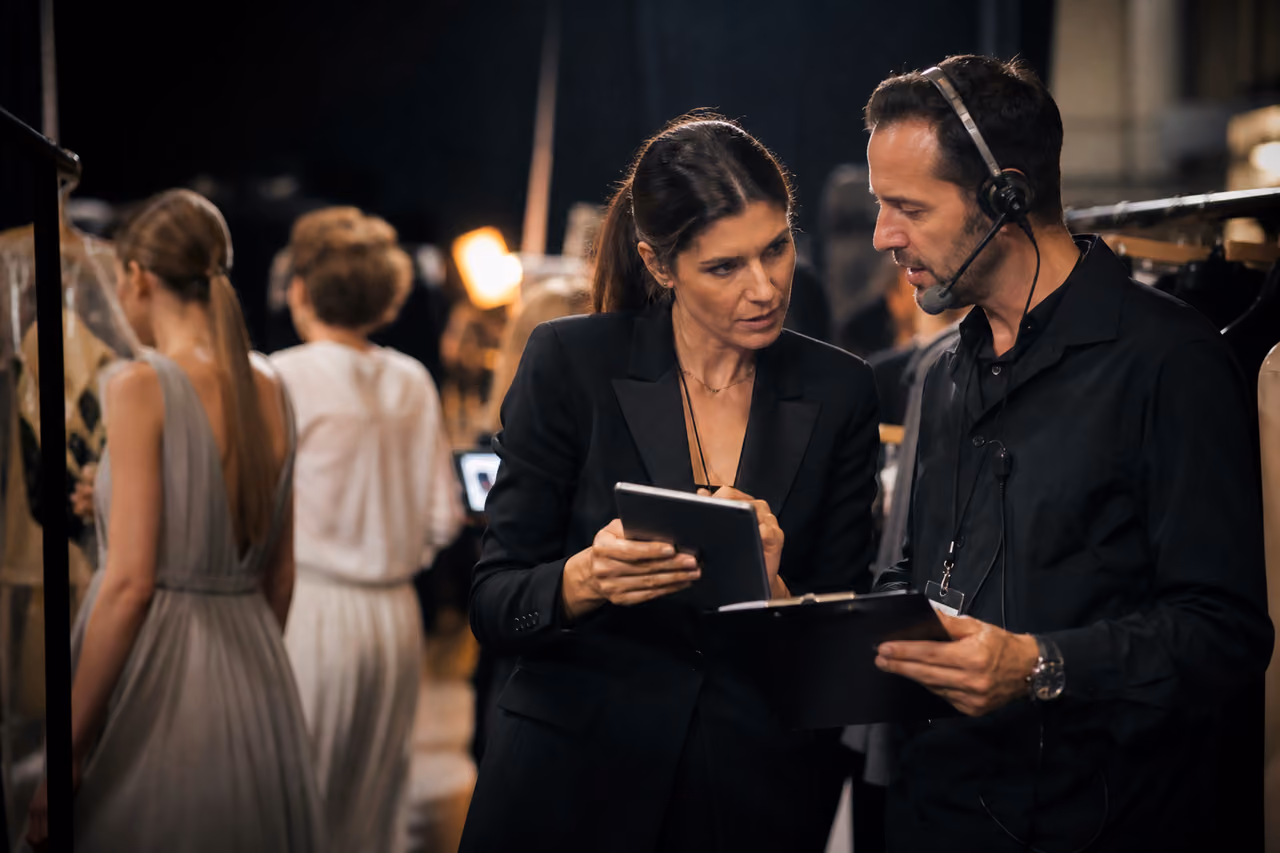 Fashion Show Organisers Coordinating Backstage During Runway Event